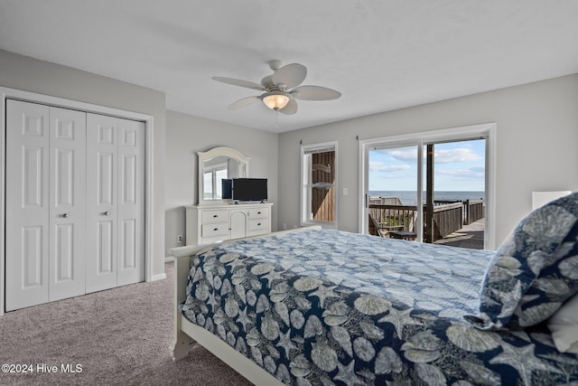 carpeted bedroom with a closet, multiple windows, a ceiling fan, and access to outside