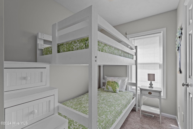 bedroom with visible vents, baseboards, and carpet floors