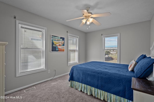 bedroom with ceiling fan, carpet, visible vents, and baseboards