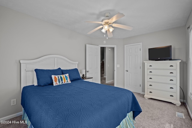 carpeted bedroom featuring baseboards and ceiling fan