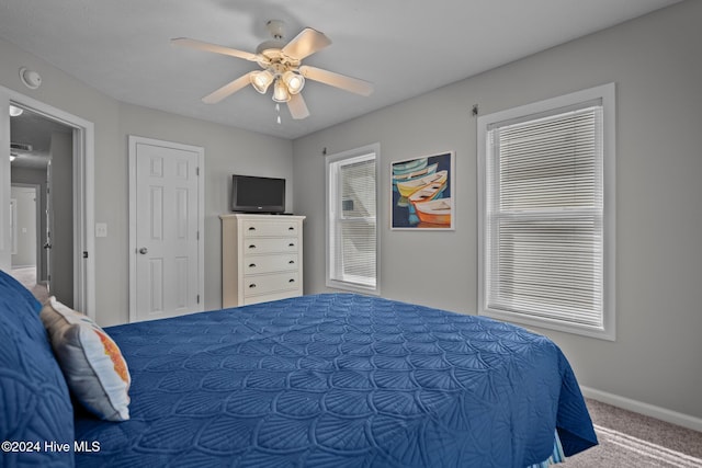 carpeted bedroom featuring a ceiling fan and baseboards