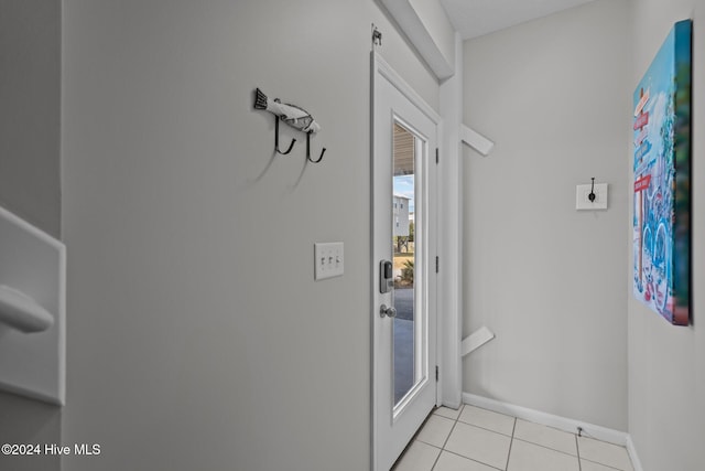 entryway featuring baseboards and light tile patterned flooring