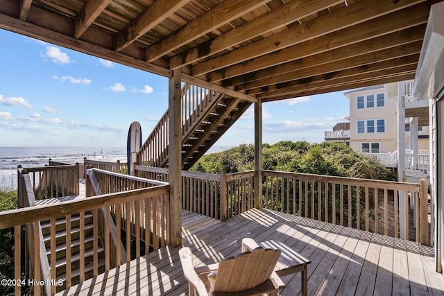 deck with stairs and a water view