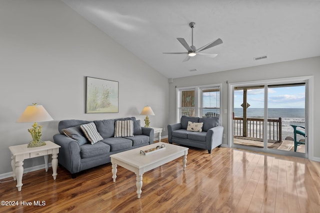 living room with visible vents, a water view, a ceiling fan, wood finished floors, and baseboards