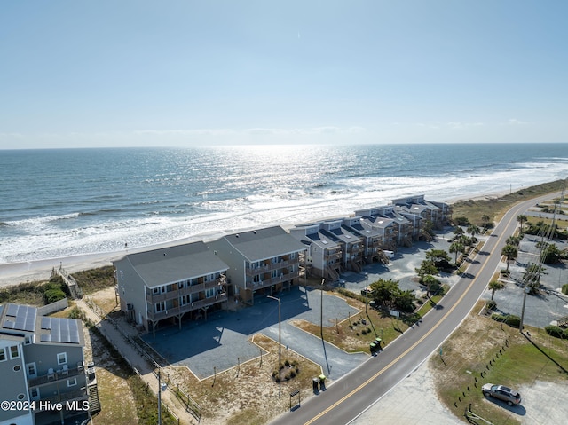 bird's eye view featuring a water view and a beach view