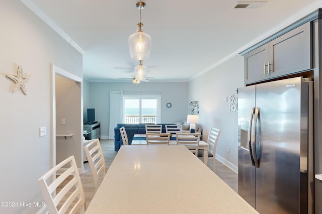 1796 New River Inlet Rd, North Topsail Beach, NC 28460 - dining area featuring light wood-style flooring, ornamental molding, a ceiling fan, and baseboards
