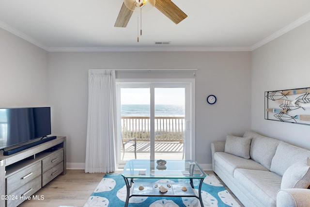 living room with a water view, crown molding, ceiling fan, and light hardwood / wood-style flooring