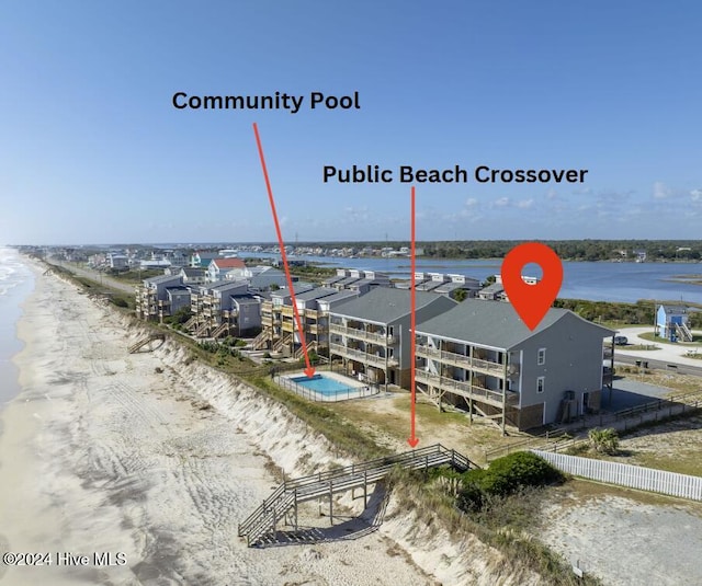 birds eye view of property with a view of the beach and a water view