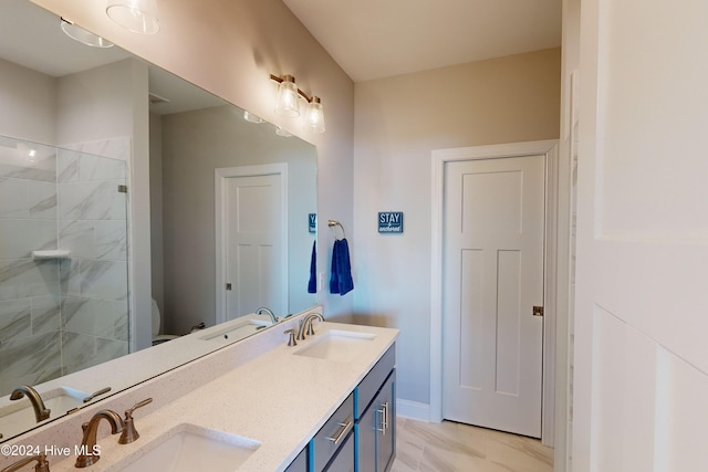 1796 New River Inlet Rd, North Topsail Beach, NC 28460 - bathroom featuring double vanity, tiled shower, toilet, marble finish flooring, and baseboards