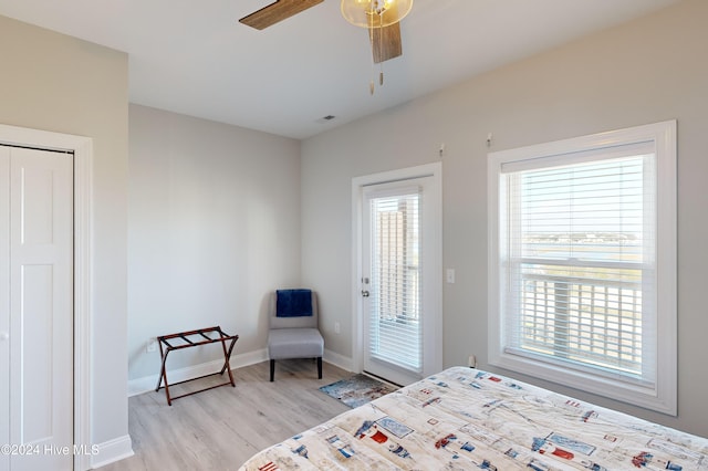 bedroom with light hardwood / wood-style flooring, multiple windows, ceiling fan, and access to exterior