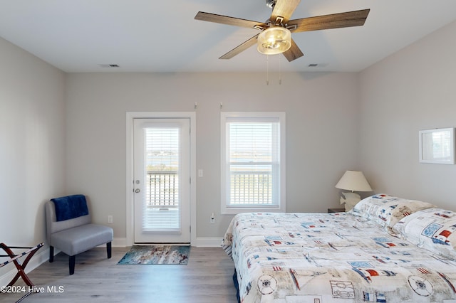 bedroom featuring access to outside, light hardwood / wood-style flooring, and ceiling fan