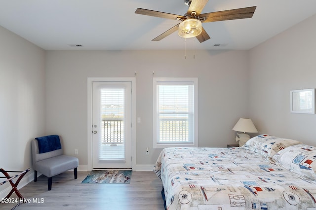 1796 New River Inlet Rd, North Topsail Beach, NC 28460 - bedroom with access to outside, wood finished floors, baseboards, and a ceiling fan