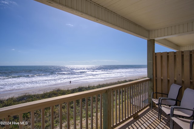 balcony with a beach view and a water view