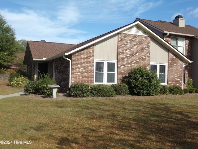 view of property exterior featuring a lawn