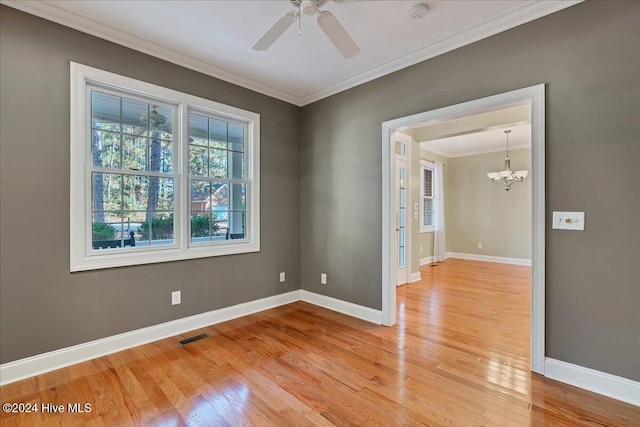 unfurnished room featuring light hardwood / wood-style floors, ceiling fan with notable chandelier, and ornamental molding