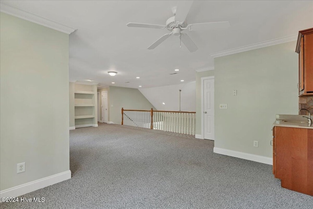 carpeted empty room featuring ceiling fan and crown molding