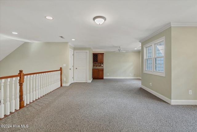 unfurnished room with carpet flooring, ceiling fan, and crown molding