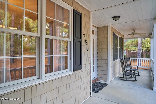 doorway to property with ceiling fan and a porch