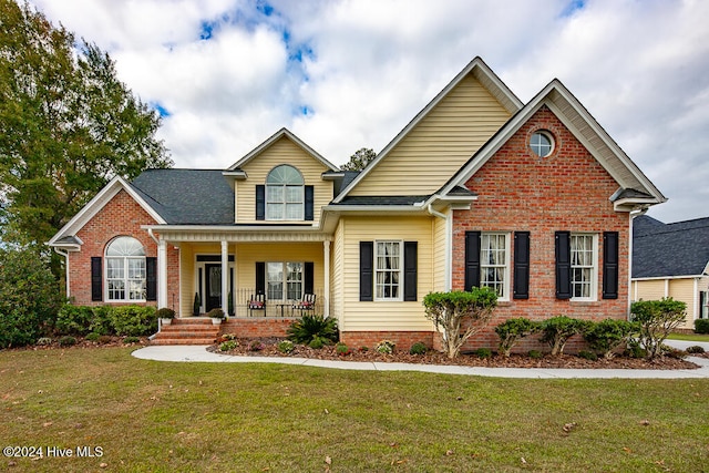 view of front of house with a porch and a front yard