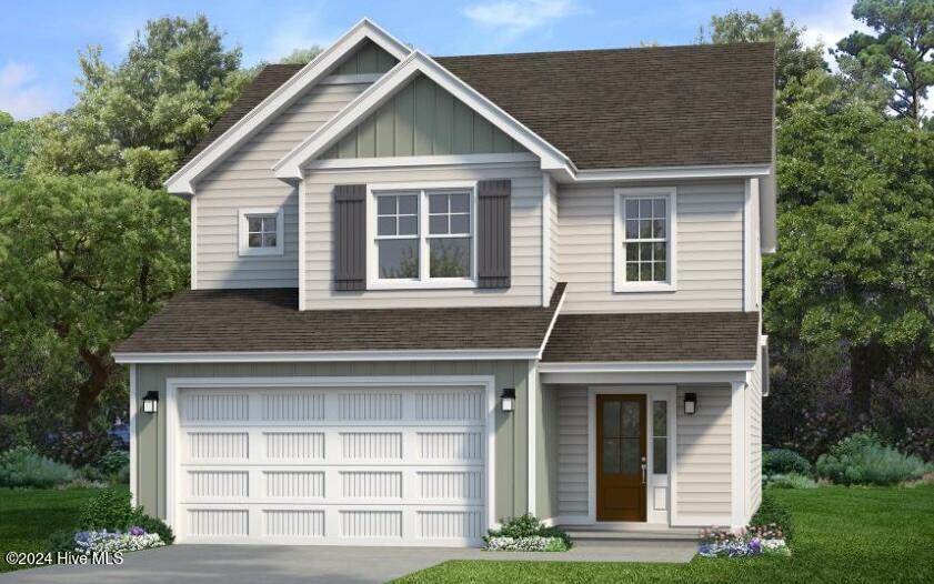 view of front of property with a garage and a front yard