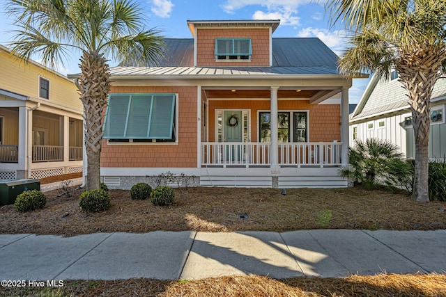 bungalow-style house featuring covered porch, metal roof, crawl space, and a standing seam roof