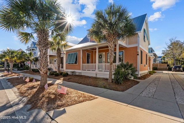 view of front of home with covered porch and metal roof