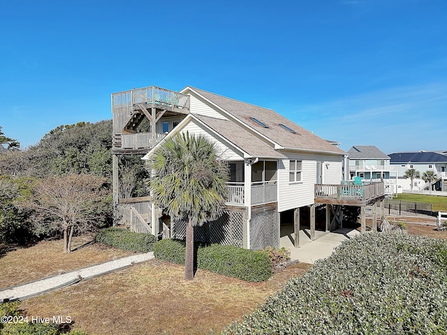 back of property with a wooden deck