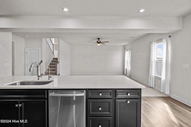 kitchen featuring light wood-type flooring, stainless steel dishwasher, ceiling fan, and sink