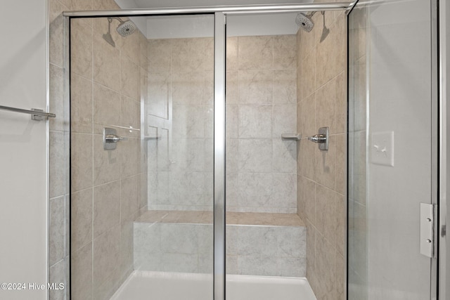 bathroom with a shower with door