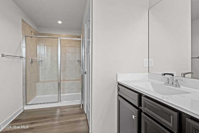 bathroom featuring hardwood / wood-style floors, vanity, and an enclosed shower