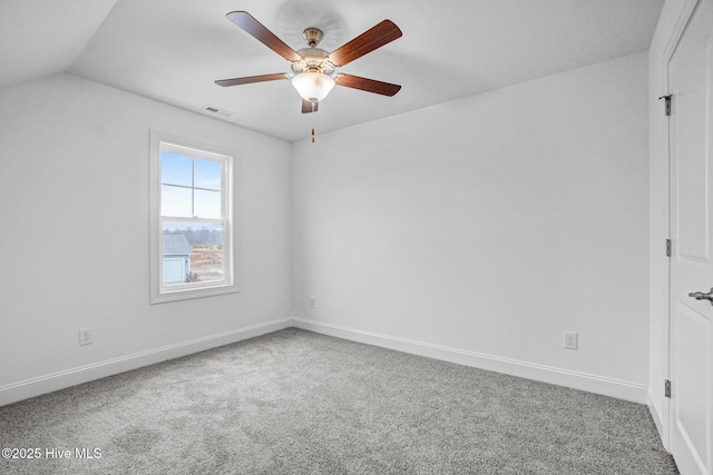 carpeted empty room with vaulted ceiling and ceiling fan