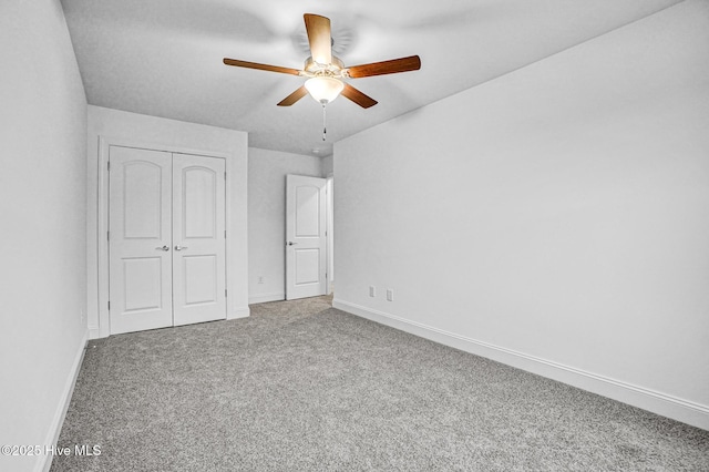 unfurnished bedroom featuring carpet floors, a closet, and ceiling fan