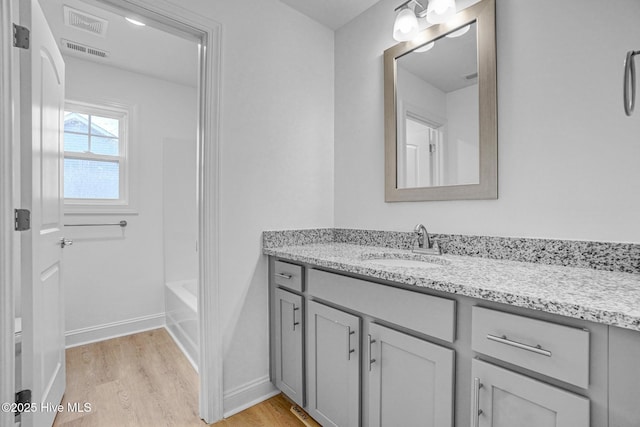 bathroom featuring vanity and hardwood / wood-style flooring