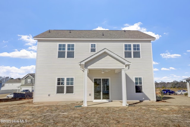 rear view of house featuring ceiling fan and a patio area