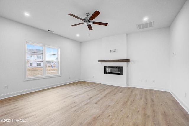 unfurnished living room with ceiling fan and light hardwood / wood-style floors