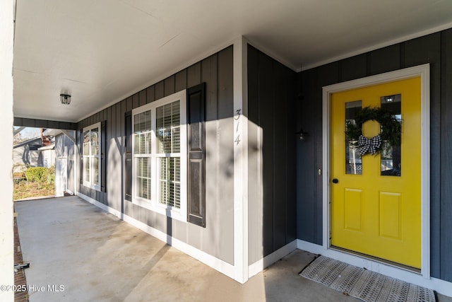 property entrance featuring a porch and board and batten siding