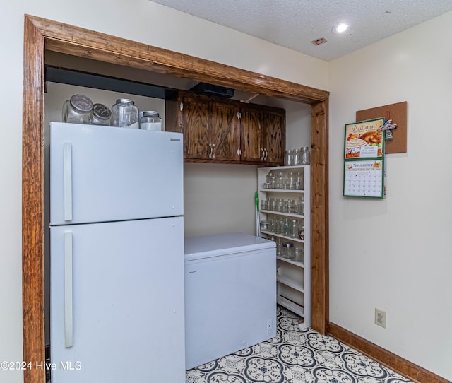 laundry room featuring a textured ceiling