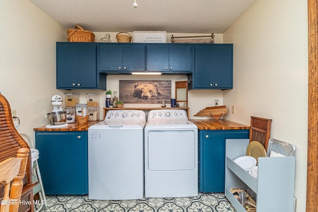 103 Shamrock Rd, Goldsboro, NC 27530 - laundry room featuring washing machine and clothes dryer, cabinet space, and a textured ceiling