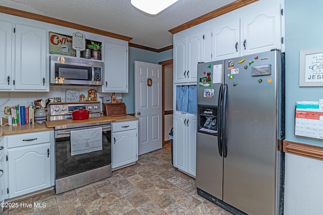 103 Shamrock Rd, Goldsboro, NC 27530 - kitchen featuring stainless steel appliances, white cabinetry, a textured ceiling, open shelves, and stone finish flooring