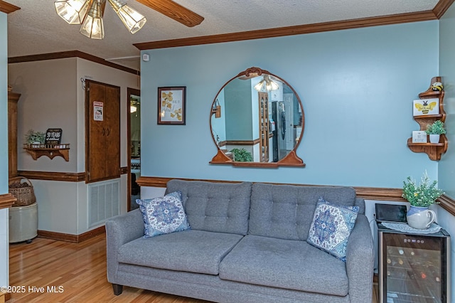 103 Shamrock Rd, Goldsboro, NC 27530 - living area featuring beverage cooler, wood finished floors, ceiling fan, a textured ceiling, and ornamental molding