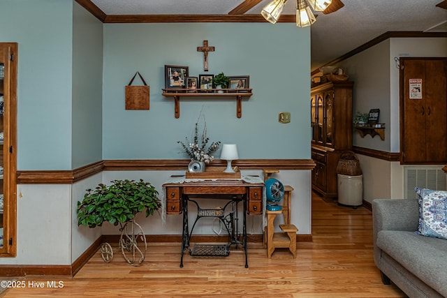 103 Shamrock Rd, Goldsboro, NC 27530 - interior space featuring light wood-style flooring, crown molding, a ceiling fan, and a textured ceiling