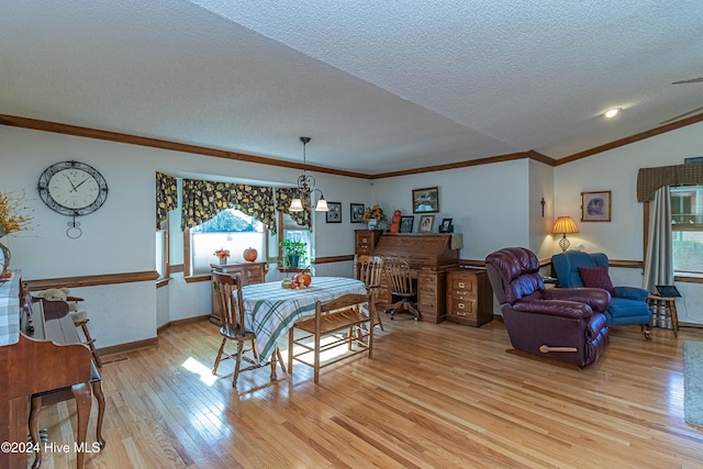 dining room featuring vaulted ceiling, a textured ceiling, a chandelier, crown molding, and light wood-type flooring