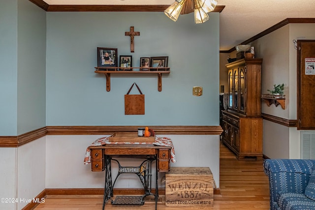 dining room with light hardwood / wood-style floors and ornamental molding