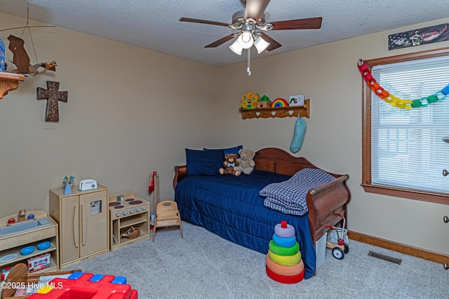 103 Shamrock Rd, Goldsboro, NC 27530 - bedroom with carpet flooring, a textured ceiling, and ceiling fan