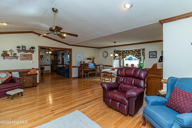 living room featuring ornamental molding, a textured ceiling, light hardwood / wood-style floors, lofted ceiling, and ceiling fan