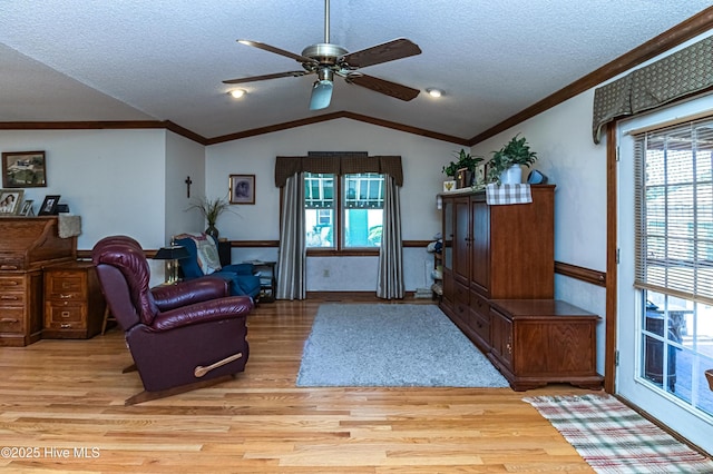 103 Shamrock Rd, Goldsboro, NC 27530 - sitting room featuring light wood-style flooring, vaulted ceiling, crown molding, ceiling fan, and a textured ceiling