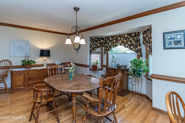 103 Shamrock Rd, Goldsboro, NC 27530 - dining area featuring light wood-style floors, a textured ceiling, ornamental molding, and baseboards