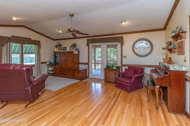 103 Shamrock Rd, Goldsboro, NC 27530 - living room featuring light wood finished floors, crown molding, a ceiling fan, lofted ceiling, and a textured ceiling