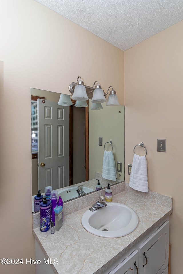 bathroom with vanity and a textured ceiling