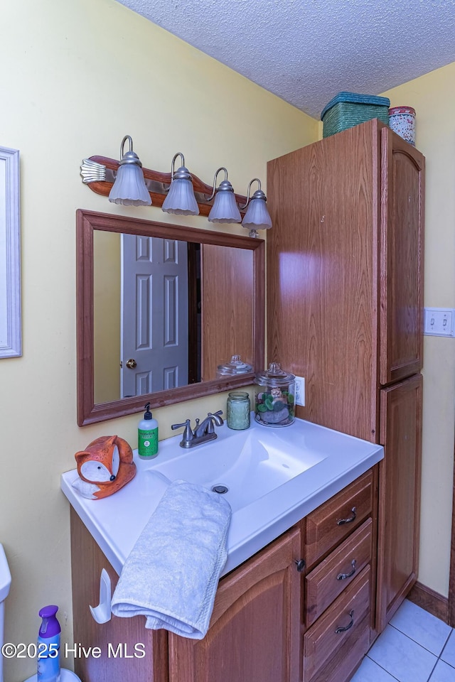 103 Shamrock Rd, Goldsboro, NC 27530 - half bath with tile patterned floors, vanity, and a textured ceiling